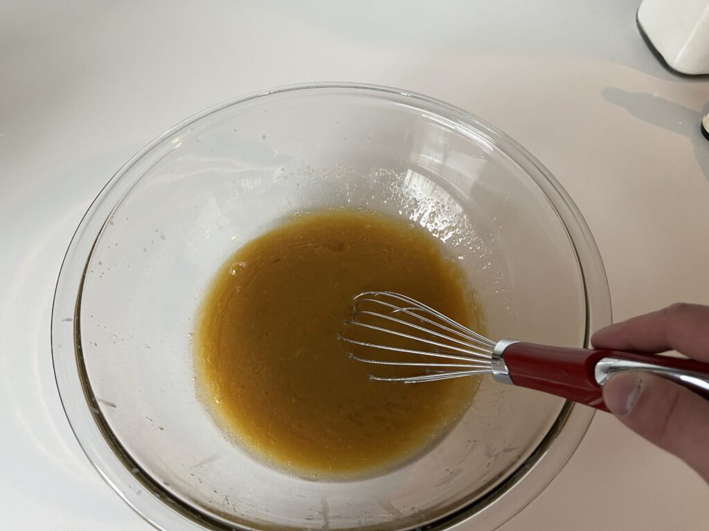 oil and sugar whisked together in a mixing bowl.