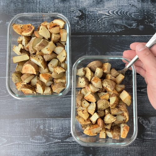 garlic roasted potatoes diced in glass meal prep containers.