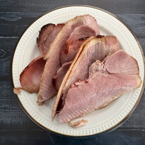 stack of glazed ham on a plate.