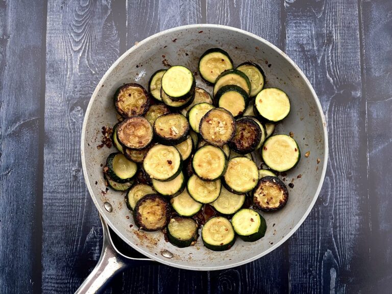 sauteed zucchini in a frying pan with garlic.