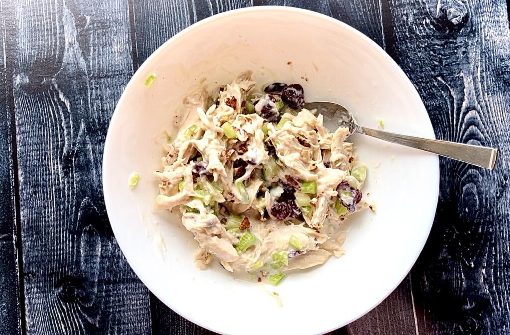 bowl of chicken salad with dried cranberries.