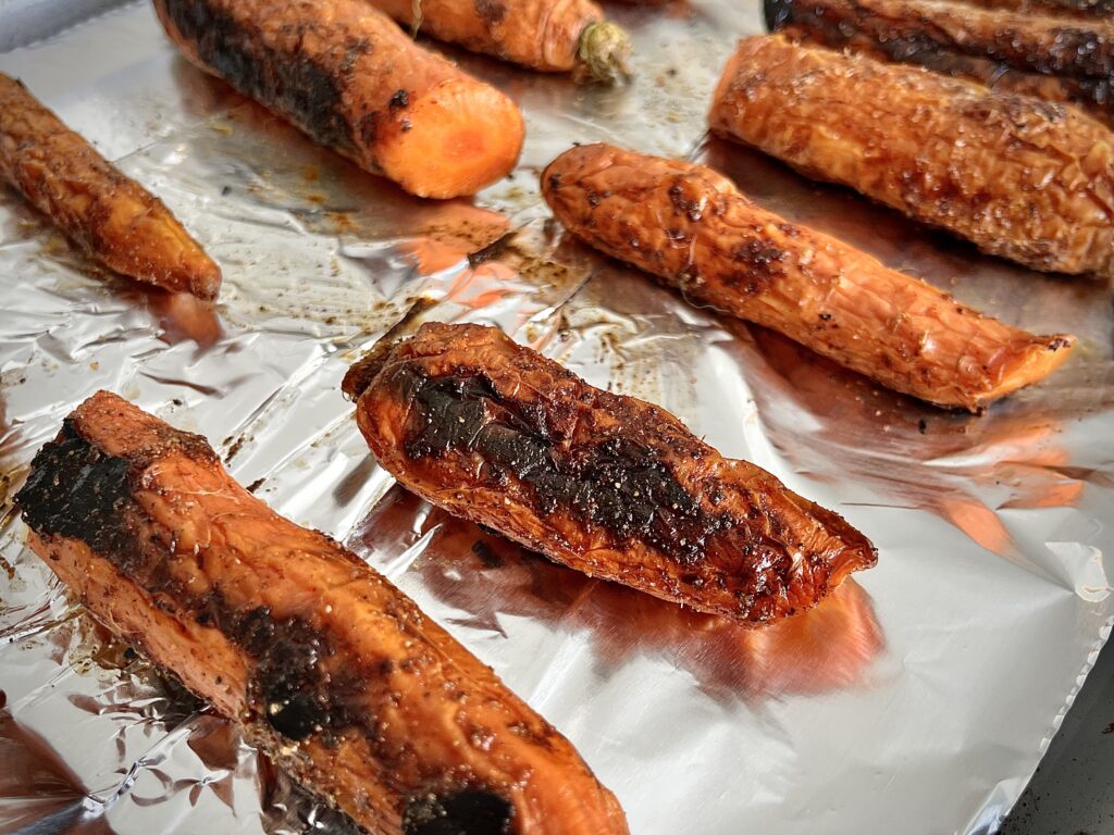 Roasted carrots on a baking sheet.