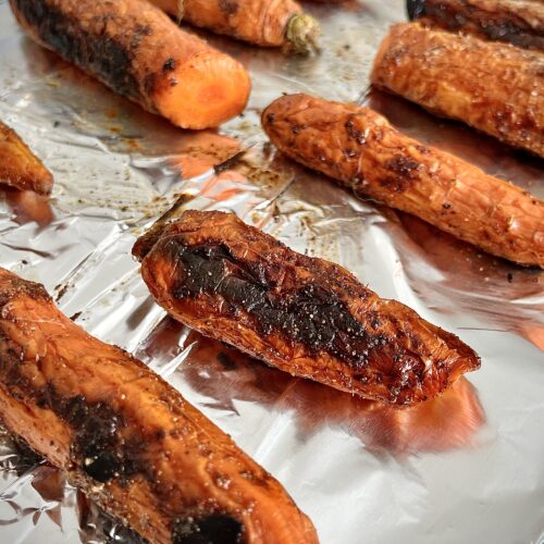 Roasted carrots on a baking sheet.