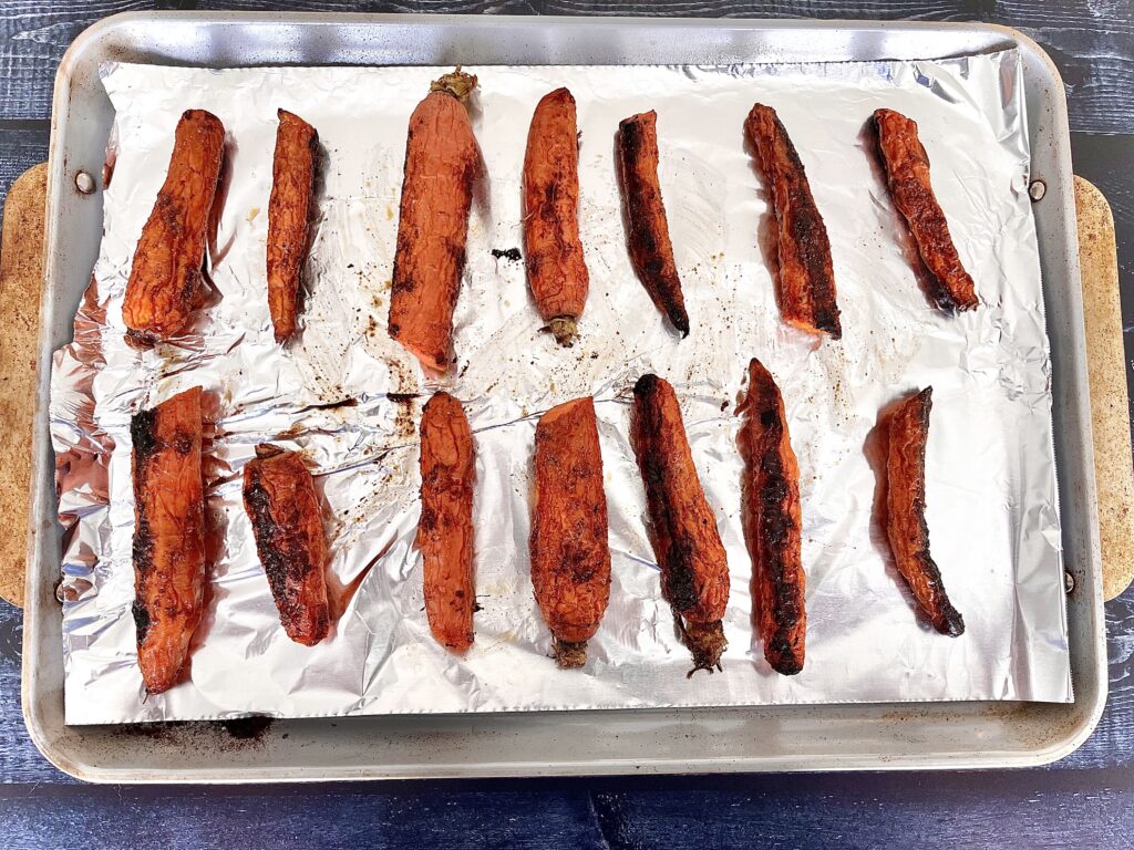 Roasted carrots on a baking sheet.