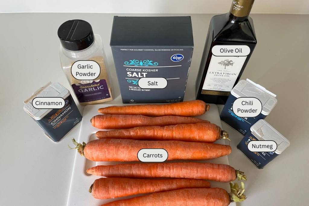 whole carrots on a cutting board with various spices.