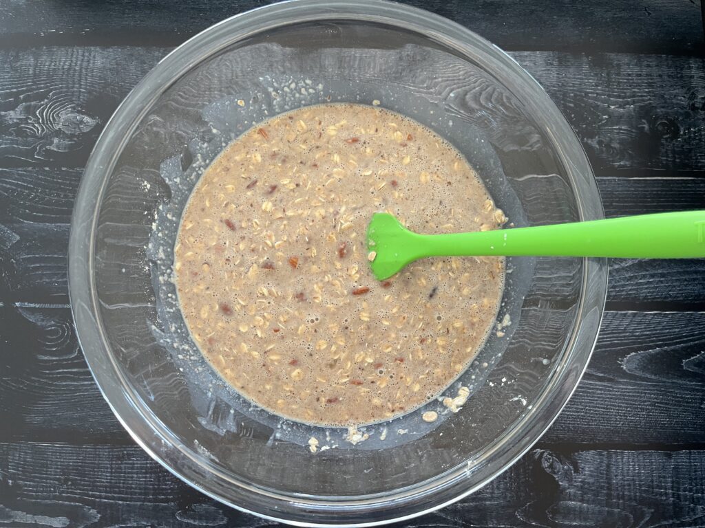 A glass bowl of oatmeal mix and milk.