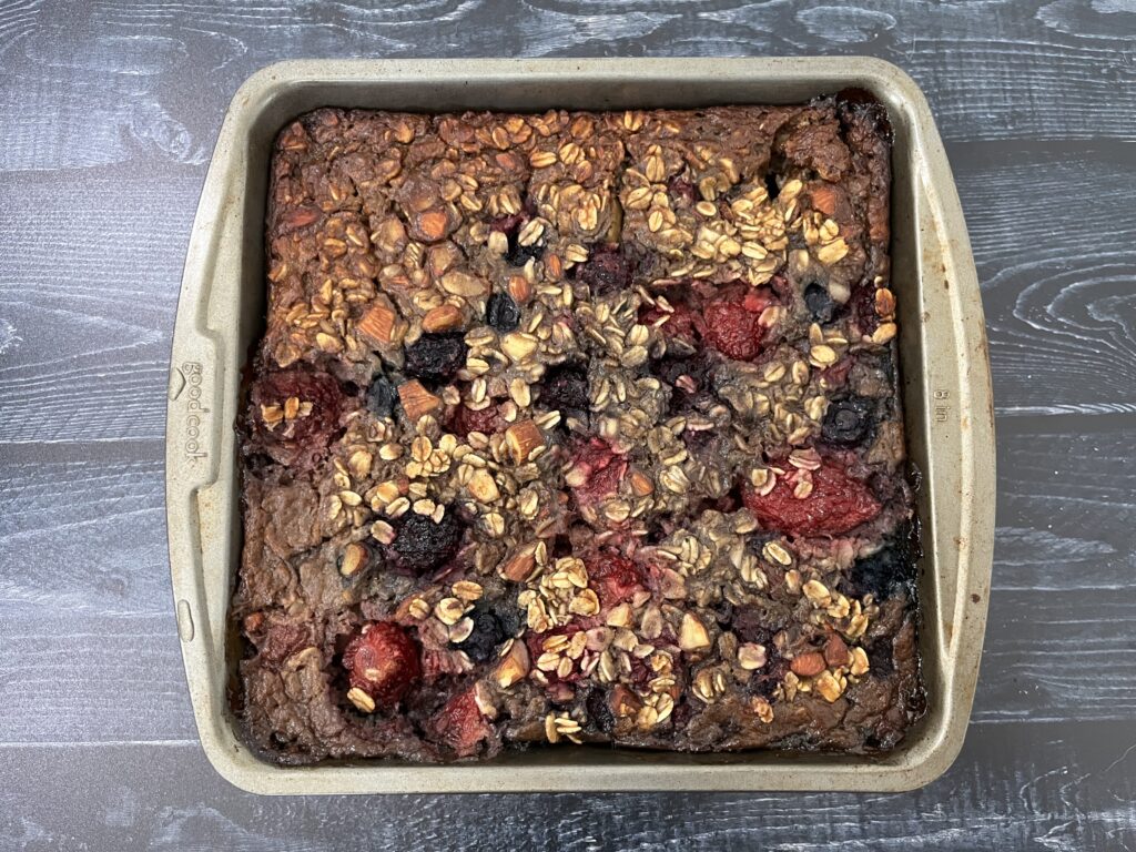 A baking dish with baked oatmeal with berries.