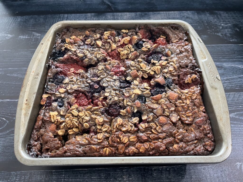 A baking dish with baked oatmeal with berries.