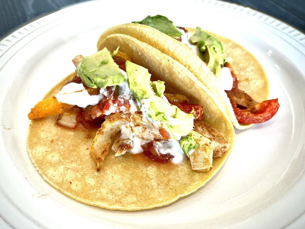 Chicken fajitas in taco shells.
