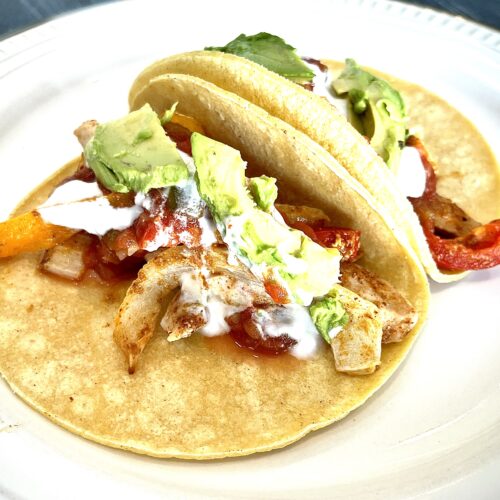 Chicken fajitas in taco shells.