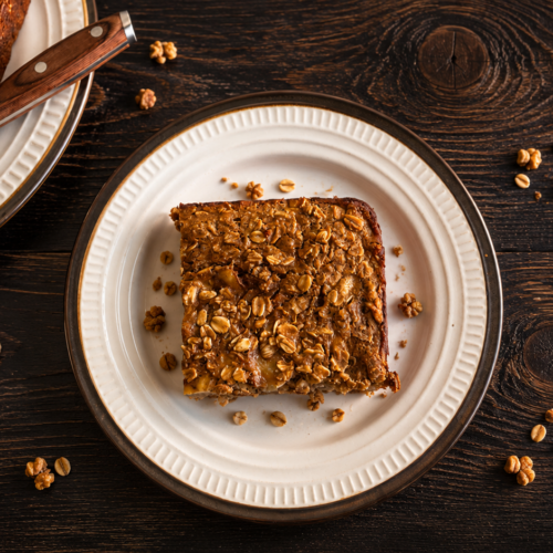 A square of banana baked oatmeal on a wooden table.