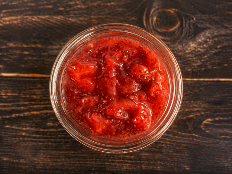 A jar of strawberry chia jam with chunks of strawberries.
