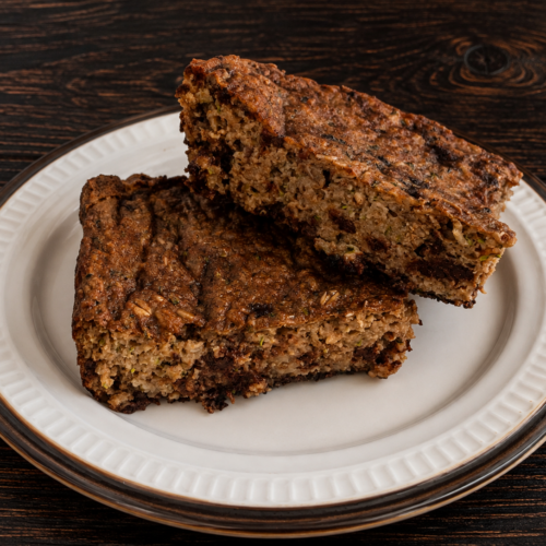 Two slices of double-chocolate zucchini baked oats on a plate.